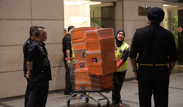 Cash-filled designer handbags seized in raids on former Malaysian PM’s apartments