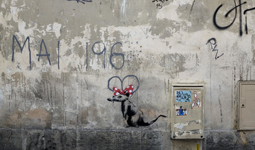 Street artist Banksy splashes Paris with works on migrants