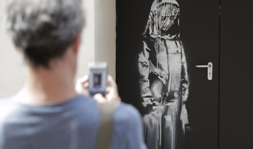 New ‘Banksy’ mural of veiled woman in mourning appears next to Bataclan in Paris