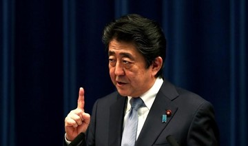 Japan PM Abe keeps key ministers in cabinet revamp