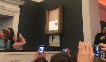 Banksy shocks art world by shredding £1 mn work at auction