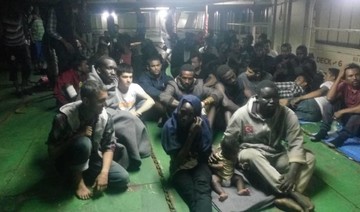 Dozens of migrants refuse to leave container ship in Libya