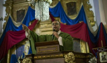 Priest under siege in battle over Venezuela's political soul
