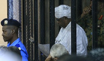 Sudan’s ex-president Omar Al-Bashir appears in cage in court as corruption trial gets underway