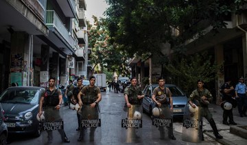 Greek police raid Athens squats, arrest migrants