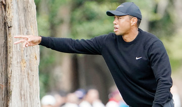 Tiger Woods shoots 64 and ties for lead in Japan