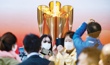 Thousands flock to see Olympic flame in Japan despite virus fears