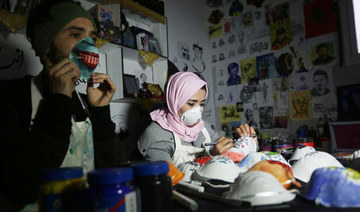 Artist masks spread healthy message in virus-hit Gaza