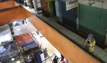 Jakarta imposes partial lockdown as virus cases surge