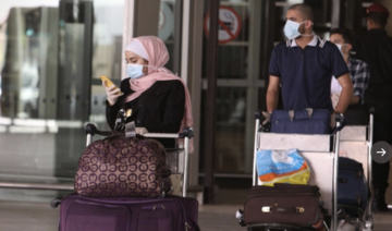 Jordan slaps wristbands on arrivals to monitor virus quarantine