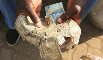 Zimbabweans mend shabby dollar notes amid economic crisis
