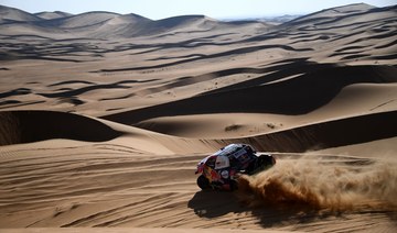 Toyota’s driver Nasser Al-Attiyah of Qatar and his co-driver Mathieu Baumel of France compete during Stage 2 of the Dakar Rally 2021 between Bisha and Wadi Ad-Dawasir in Saudi Arabia, on January 4, 2021. (AFP)