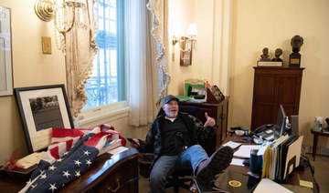 Richard Barnett, a supporter of US President Donald Trump, sits inside the office of US Speaker of the House Nancy Pelosi after followers of President Donald Trump invaded the US Capitol as Congress debated the a 2020 presidential election Electoral Vote Certification. (AFP / SAUL LOEB)
