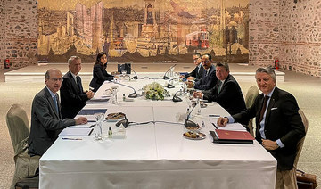 This handout picture taken and released on January 25, 2021, by the Turkish Foreign Ministry press office shows Greek diplomat Pavlos Apostolidis (2L), Turkish Deputy Foreign Minister Sedat Onal (2R), Turkish President's spokesman Ibrahim Kalin (3R) and their delegation meeting at Dolmabahce palace in Istanbul as talks resumed over Eastern Mediterranean dispute. (AFP/Turkish Foreign Ministry)