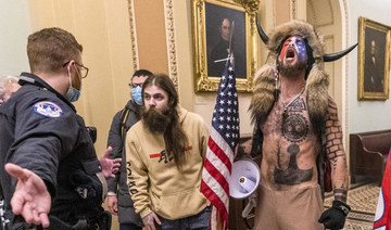 In this Jan. 6, 2021 file photo, supporters of President Donald Trump, including Jacob Chansley, with horns, are confronted by US Capitol Police officers outside the Senate Chamber inside the Capitol in Washington. (AP Photo/Manuel Balce Ceneta, File)
