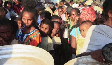 Ethiopian refugees who fled intense fighting in their homeland of Tigray, wait for their ration of food in the border reception centre of Hamdiyet, in the eastern Sudanese state of Kasala, on November 14, 2020. (AFP/File Photo)