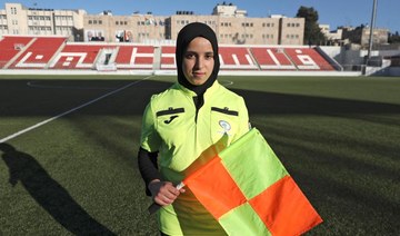 Palestinian Hanin Abu Mariam, a 21-year-old female referee, poses for a picture after a football match at Faisal Al-Husseini International Stadium in the West Bank city of Al-Ram, north of Jerusalem, on February 11, 2021. (AFP)