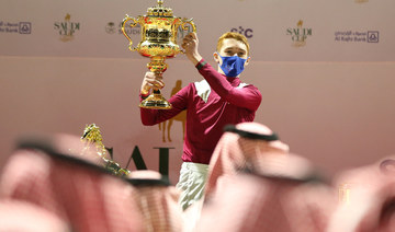 Jockey David Egan celebrates with the trophy after winning the Saudi Cup riding Mishriff. (Reuters)