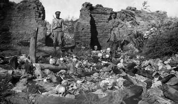 A picture released by the Armenian Genocide Museum-Institute dated 1915 purportedly shows soldiers standing over skulls of victims from the Armenian village of Sheyxalan in the Mush valley, on the Caucasus front during the First World War. (STR/AGMI/AFP)