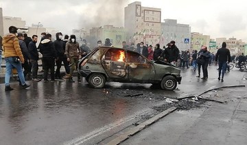 Iranian protesters gather around a burning car during a demonstration against an increase in gasoline prices in the capital Tehran, on November 16, 2019. (AFP/File Photo)