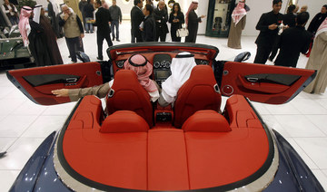 Kuwaiti men sit in a Bentley Continental GTC 2012 convertible automobile at a showroom in Kuwait City on February 13, 2012. (AFP/File Photo)
