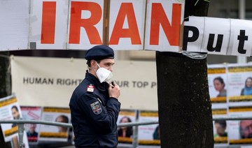 A police officer patrols in front of banners put up by members of the National Council of Resistance of Iran, an Iranian opposition group, in front of the Grand Hotel Wien. (AFP)