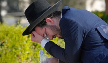 An Ultra-Orthodox Jew mourns at Segula cemetery in Petah Tikva during the funeral of a victim of Jewish pilgrim stampede, on April 30, 2021. (AFP)