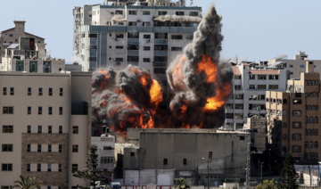 Smoke billows as a bomb is dropped on the Jala Tower during an Israeli airstrike in Gaza city controlled by the Palestinian Hamas movement, on May 15, 2021. (AFP)