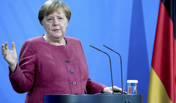 Germany lifts more restrictions, Merkel urges caution