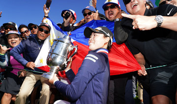Yuka Saso hoists the US Open trophy with a group of spectators after beating Nasa Hataoka in the final round of the US Women's Open golf tournament on June 6, 2021 in San Francisco. (Kyle Terada-USA TODAY Sports)