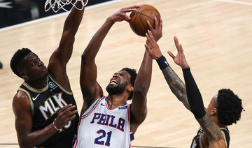 Joel Embiid #21 of the Philadelphia 76ers drives against Clint Capela #15 and John Collins #20 of the Atlanta Hawks. (Kevin C. Cox/Getty Images/AF)