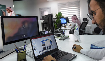 A picture taken on August 17, 2017 shows a Saudi employee using a laptop to prepare a slideshow at his office in the capital Riyadh. (AFP/File Photo)