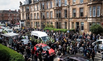 Protestors surround an Immigration Enforcement van to stop it from departing after individuals were detained in Glasgow in May. (AFP/File Photo)