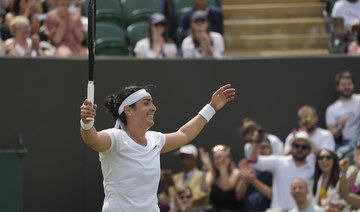 Tunisia's Ons Jabeur celebrates celebrates after defeating Poland's Iga Swiatek during the women's singles fourth round match on day seven of the Wimbledon Tennis Championships. (AP)