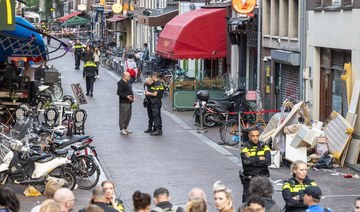 Police officers investigate the site of an attack where a Dutch journalist, Peter R. de Vries was seriously injured in a shooting in Amsterdam. (AFP)