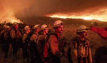 Firefighters from Cal Fire's Placerville station monitor the Sugar Fire in Doyle, California, on July 9, 2021. (AP Photo/Noah Berger)