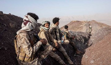 Yemeni fighters stand at a  distance from the frontline after clashes with Houthi rebels on the Kassara frontline near Marib, Yemen. (AP file photo)