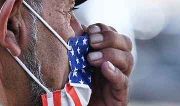 A man adjusts his American flag face mask on July 19, 2021 on a street in Hollywood, California. (AFP file photo)