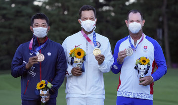 Xander Schauffele, of the US, poses with his gold medal next to bronze medal winner C.T. Pan of Taiwan, left, and silver medal winner Rory Sabbatini, of Slovakia, right, for the men's golf at the 2020 Summer Olympics. (AP)