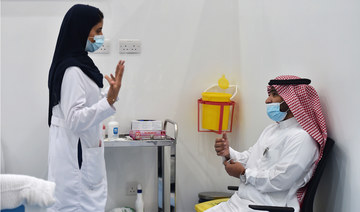 A nurse speaks to a man before administering the Pfizer-BioNTech COVID-19 coronavirus vaccine as part of a vaccination campaign by the Saudi health ministry, in Riyadh. (AFP file photo)