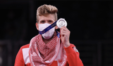 Taekwondo silver Medallist Saleh Elsharabaty of Jordan wearing a kaffiyeh celebrates after his bout. (Reuters)
