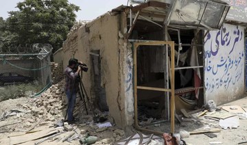 An Afghan journalist films the site of a bomb explosion in Kabul. (File/AP)