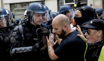 Protesters and police face during a protest against the vaccine and vaccine passports, in Paris, France, Saturday Aug. 7, 2021. (AP)