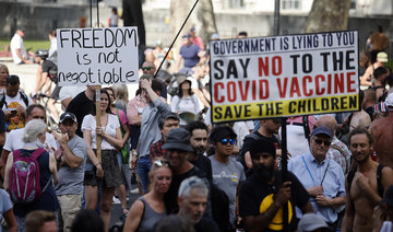 Protesters hold up placards at a demonstration against government lockdown restrictions in Parliament Square in central London on June 14, 2021. (File/AFP)