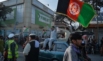 People carry the Afghanistan's national flag on the occasion of 102th Independence Day of the country in the Wazi Akbar khan area of Kabul on August 19, 2021 amid the Taliban's military takeover of Afghanistan. (AFP)