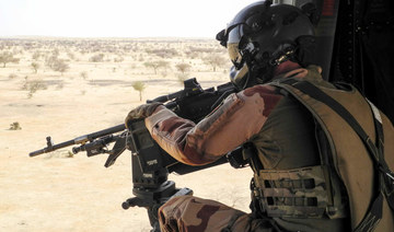 A French soldier from the Barkhane mission in Africa's Sahel region, points a machine gun from a NH90 helicopter between Gao and Menaka, Mali, on March 21, 2019. (AFP)