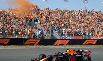 Red Bull's Dutch driver Max Verstappen salutes the crowd after he clocked the best time of the qualifying session of the Netherlands' Formula One Grand Prix at the Zandvoort circuit. (AFP)