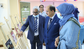 Philatelist Mirza Mohammed Nawab (L) giving a tour of his stamp collection to Dr. Ausaf Sayeed (C) and the ambassador’s wife Farah Sayeed (R). (AN Photo)