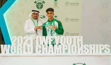 Ali Majed celebrates Mohammed Al-Hardi, President of the Saudi Arabian Weightlifting Federation. (Supplied/SAWF)