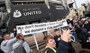 Newcastle United supporters celebrate outside the club's stadium St James' Park in Newcastle upon Tyne in northeast England on October 7, 2021, after the sale of the football club to a Saudi-led consortium. (AFP)